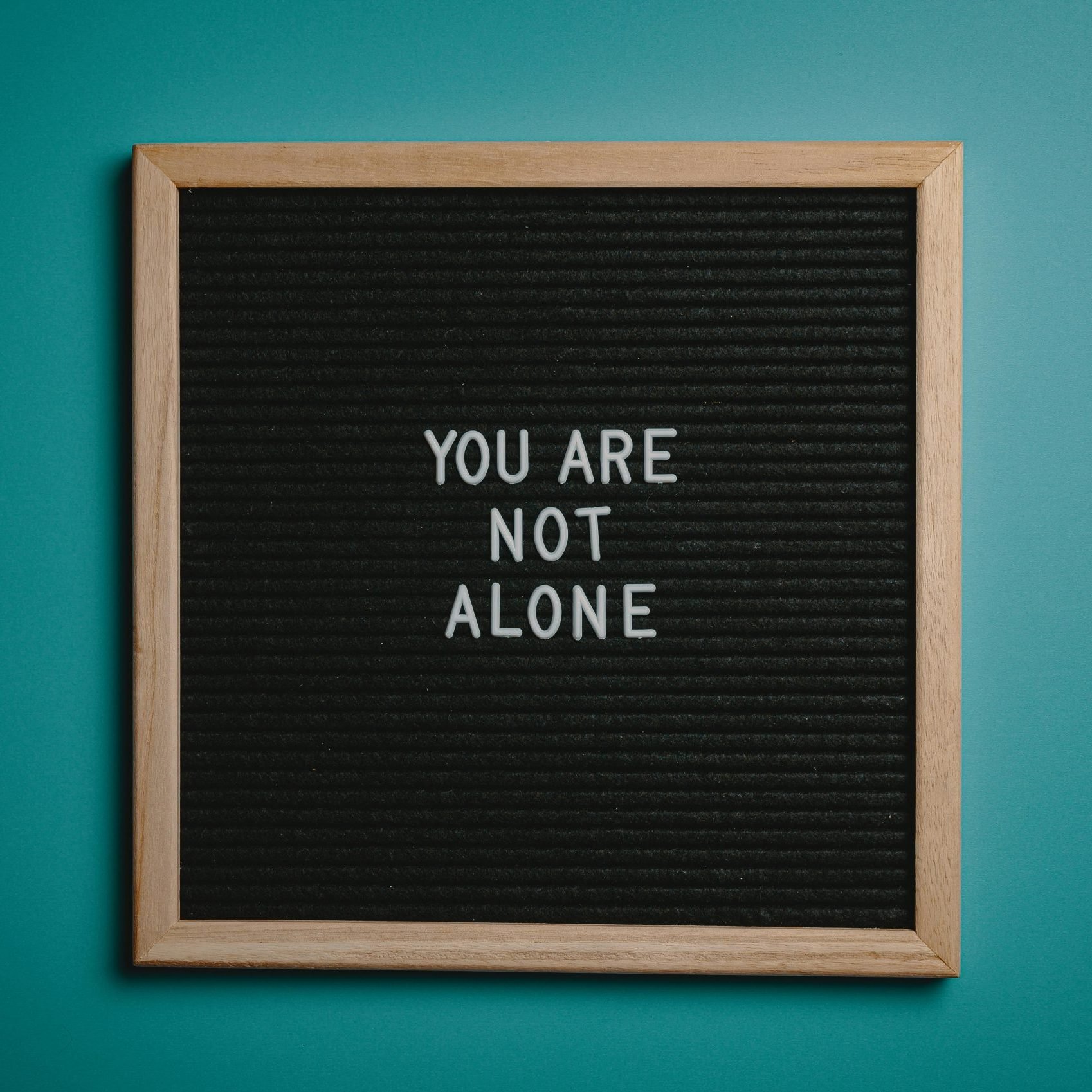 A bulletin board reading "You are not alone"