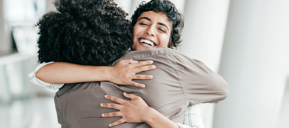 Two women hugging as a relief from anxiety.